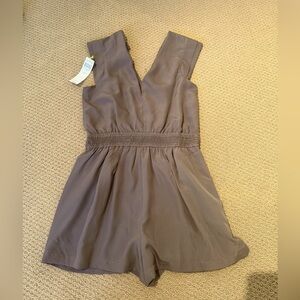 BCBG romper silk grey. New with tags. Never worn. Beautiful fit. V neck. Pockets